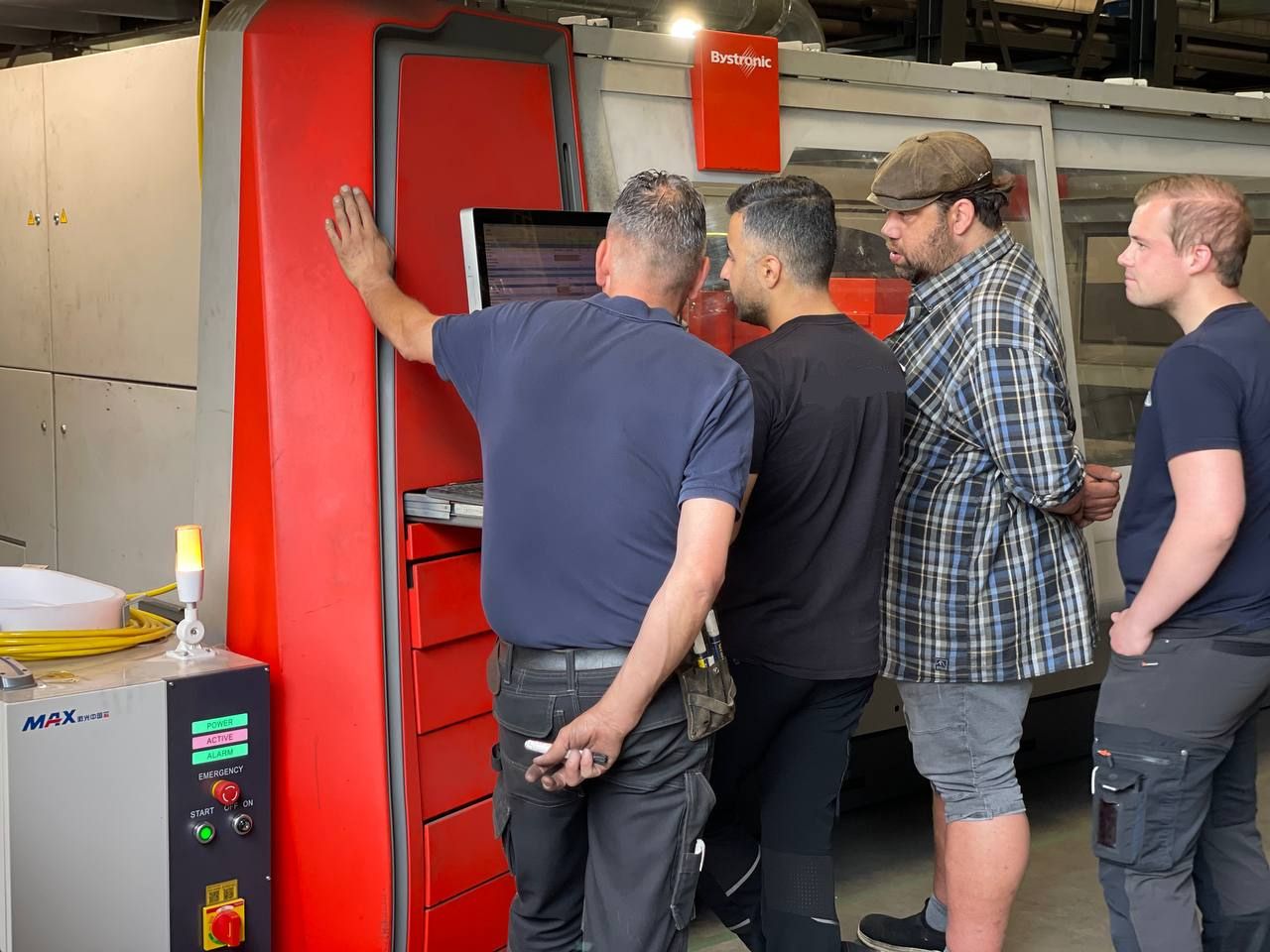 Team arbeitet an der Konfiguration einer umgerüsteten Bystronic CO2-Lasermaschine.